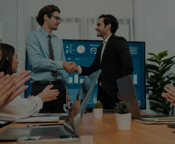 Business partners shaking hands in a modern office